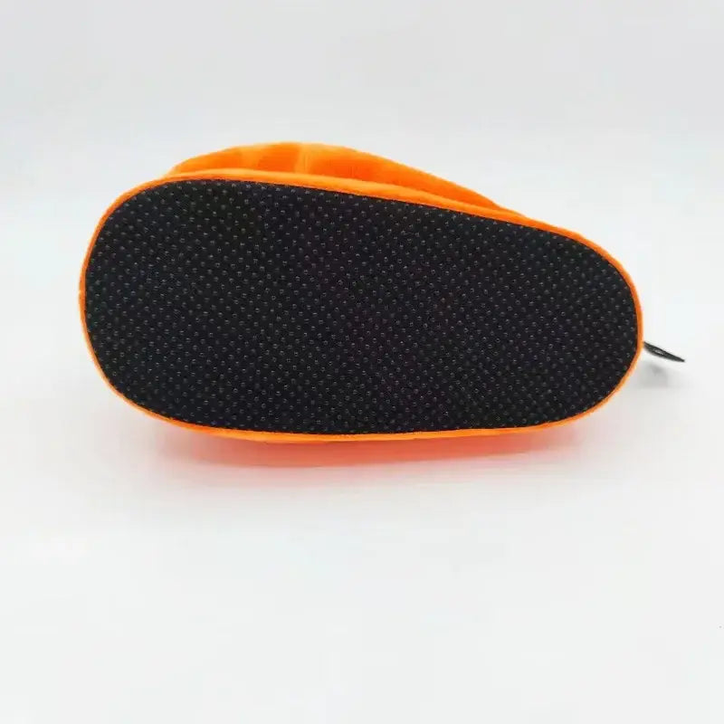 Bright orange pochita plush slipper with soft plush material and black textured sole for indoor comfort