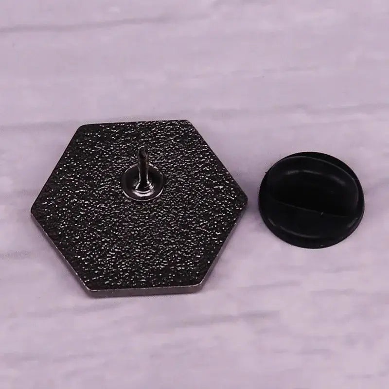 Black hexagonal evangelion eva 1 enamel pin with speckled texture and silver fastener collectible jewelry accessory