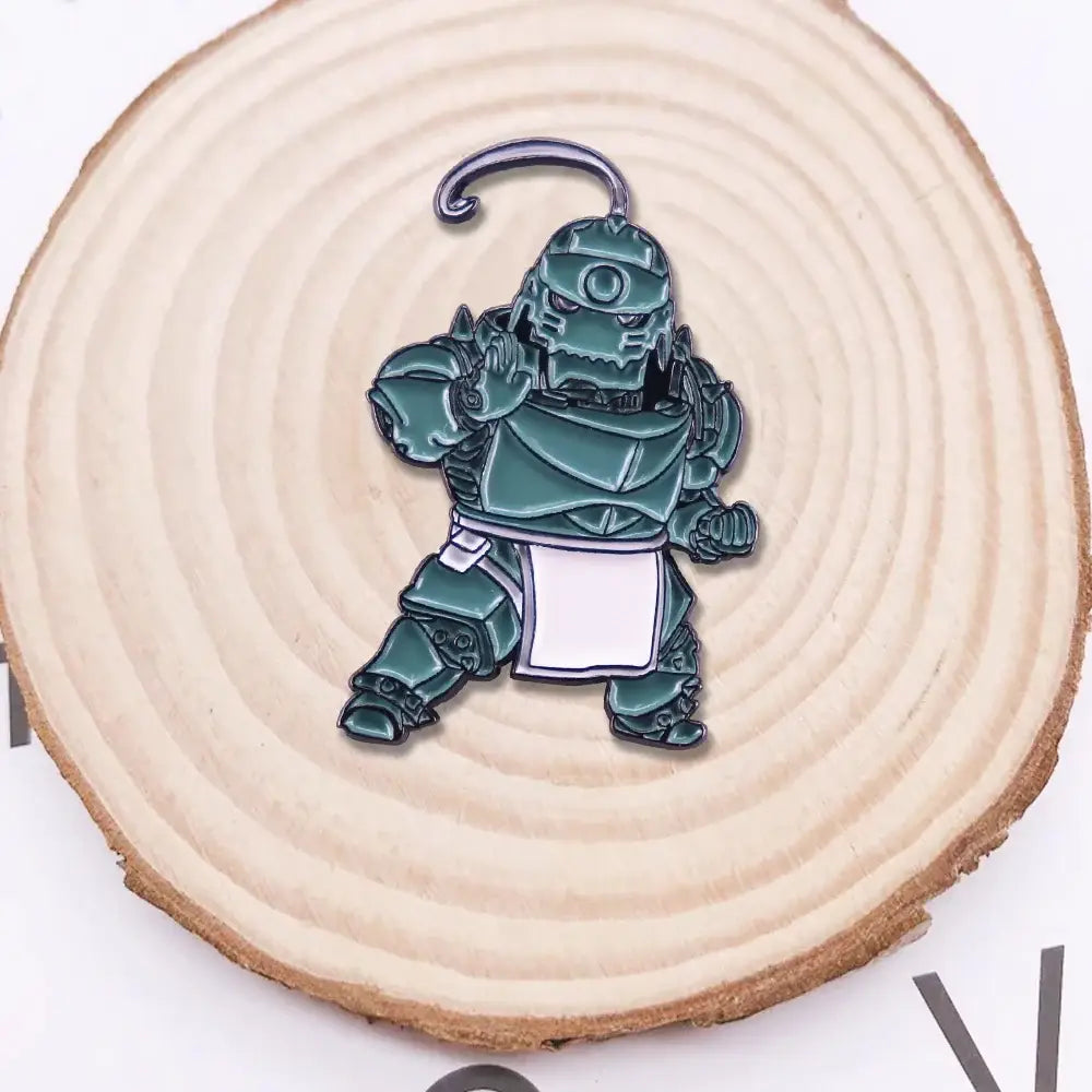 Teal enamel alphonse elric pin featuring chibi armored character with white apron and metal loop for otaku gift