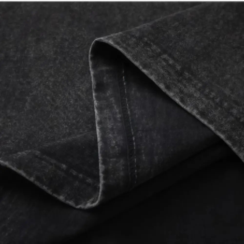 Black denim fabric with worn texture and stitching detail on the folded edge of gengar ghost oversized 100 percent cotton t shirt