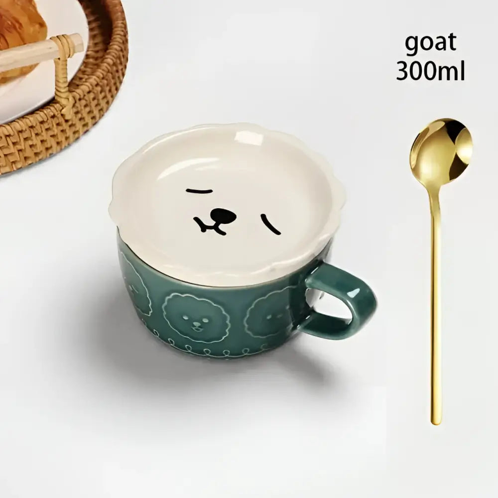 Teal ceramic japanese cat mug with white scalloped lid featuring black goat face and matching decorative patterns with small dish