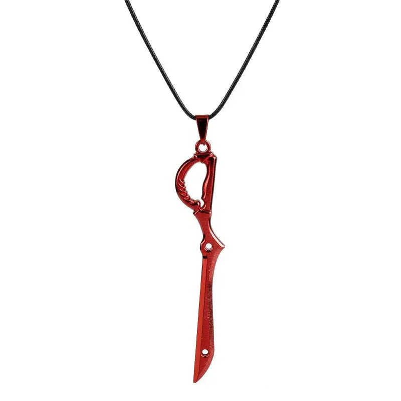 Red metallic mini metal pendant necklace shaped like stylized scissor blade with ornate handle and circular cutouts
