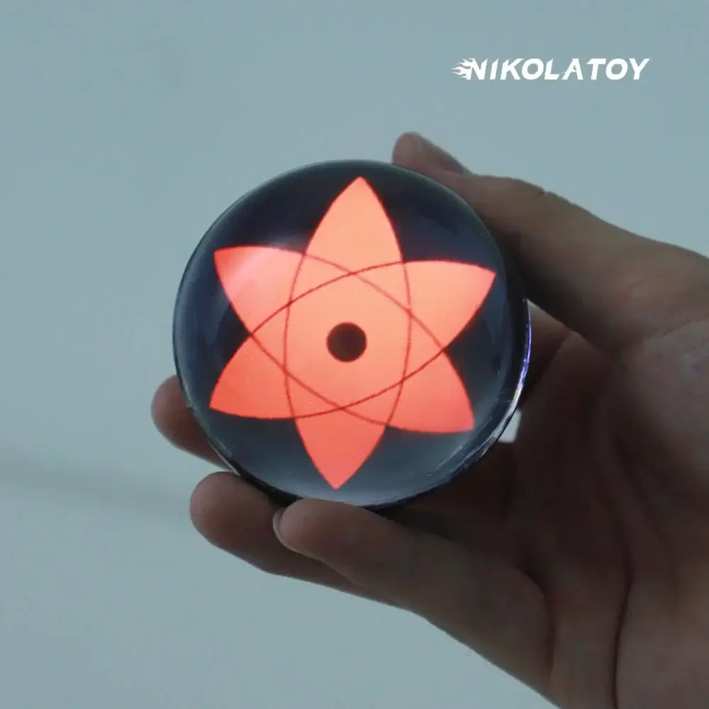 A glowing black spherical nikolatoy led crystal lamp with orange six-pointed star and red lines featuring music rhythm sync