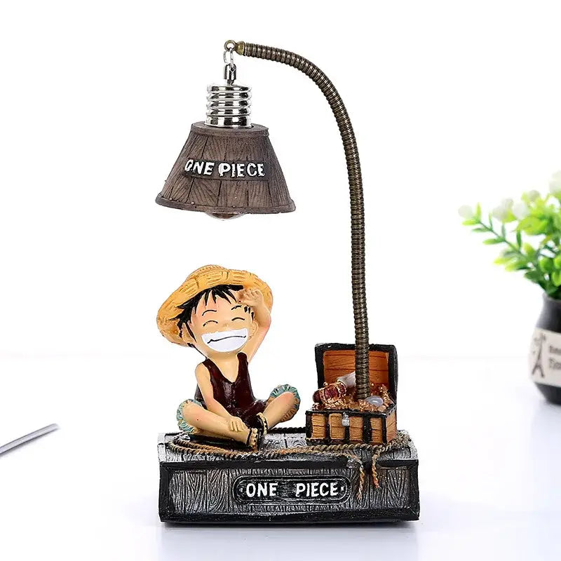 One piece luffy chopper led desk lamp featuring a smiling luffy figurine and open treasure chest with branded base and shade
