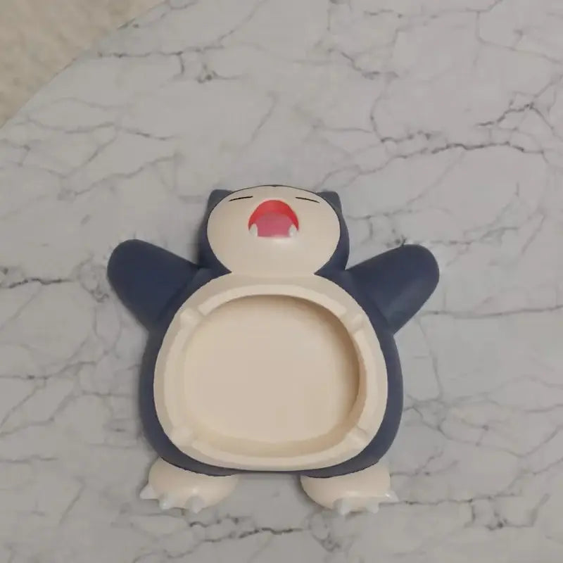 Pokemon snorlax ashtray ornament in dark blue and cream with a red mouth designed as a playful desktop decor accessory