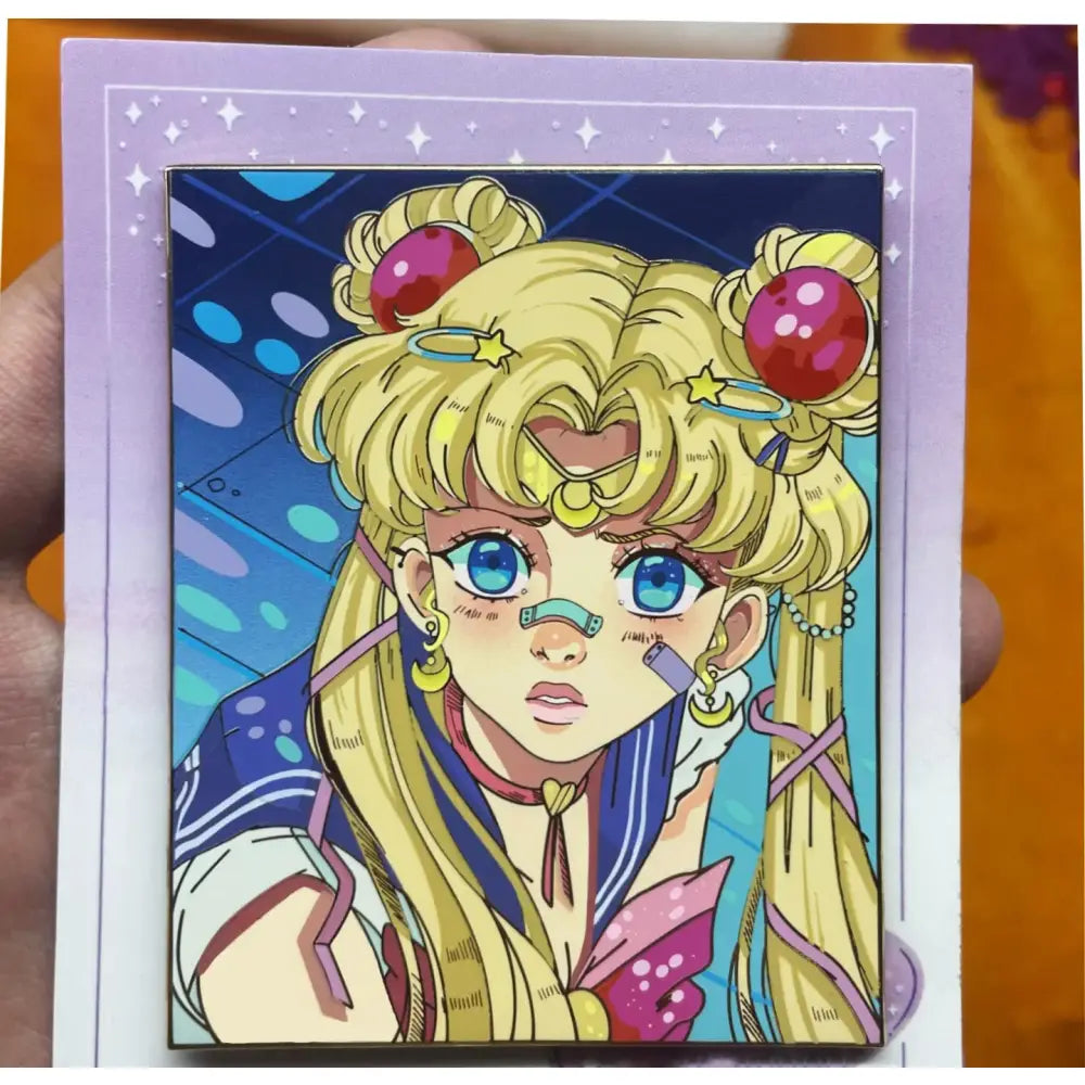 A vibrant anime fantasy enamel pin featuring sailor moon as a blonde girl warrior with blue eyes and red bun accessories