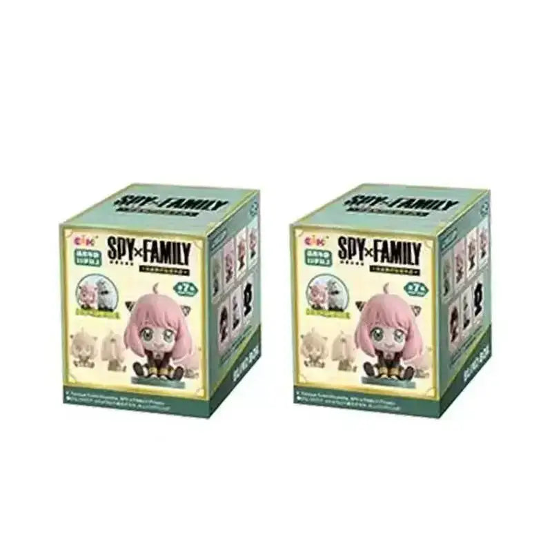 Two light green and cream spy x family blind box figures featuring family anya sitting pvc desktop dolls with pink hair and cat ears