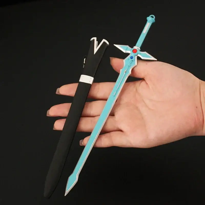 A light blue plastic sword with cross-shaped hilt and gem accents held next to black sheath for sword art online cosplay
