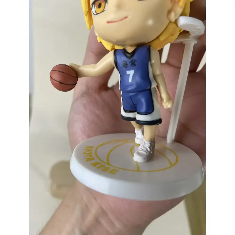 A 10cm chibi anime pvc action figure of blonde basketball player in blue white jersey number 7 with ball delivered intact in retail box