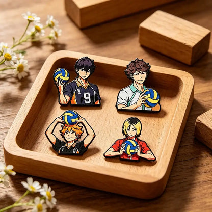 Set of four colorful anime volleyball player enamel pins on wooden tray perfect for coat lapel badges gift