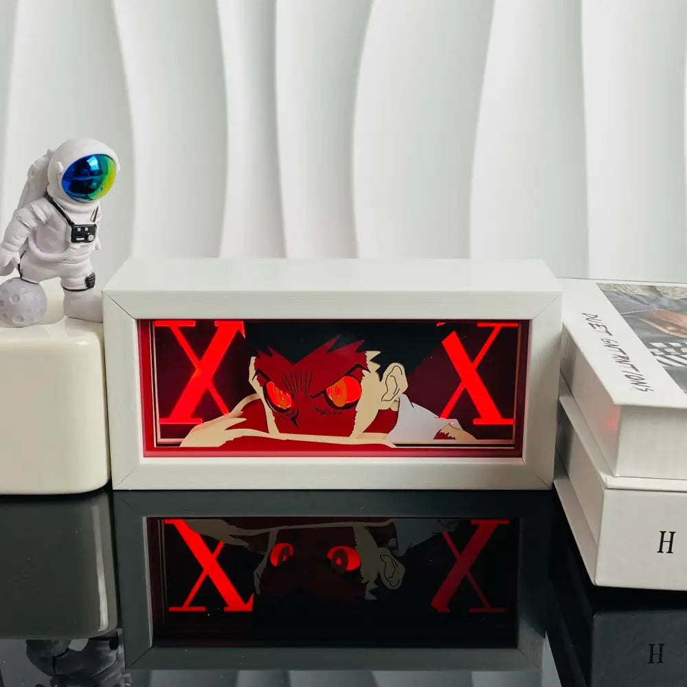 White rectangular led light box featuring a glowing red anime character with bold x lettering in a 3d paper carved lamp