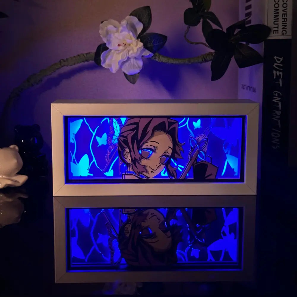 White-framed illuminated anime 3d paper carved lamp with blue led backlighting and butterfly motifs in display box