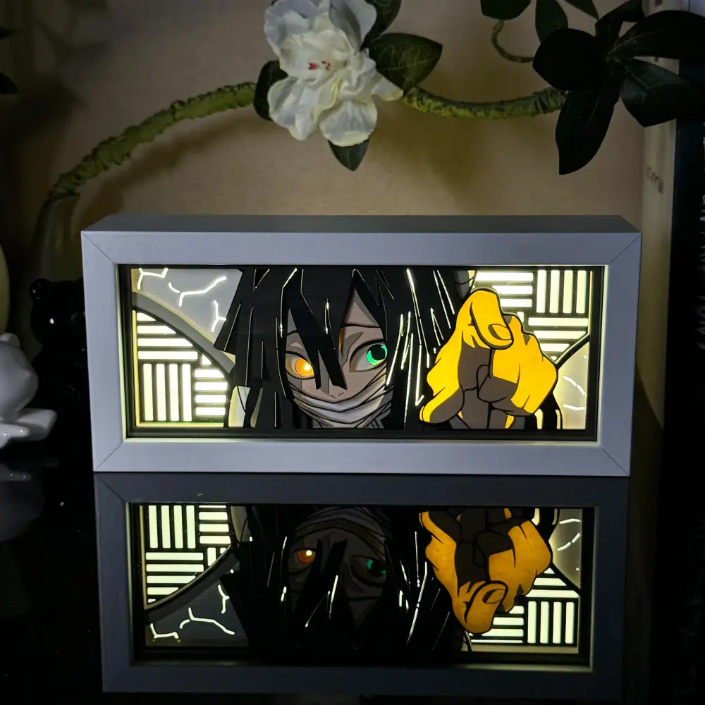 A sleek silver-framed anime 3d paper carved lamp with led light featuring a glowing character with black hair and dual-colored eyes