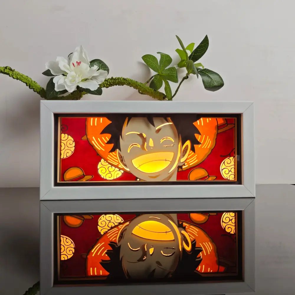 White-framed anime 3d paper carved lamp featuring a glowing smiling orange-haired character on red background