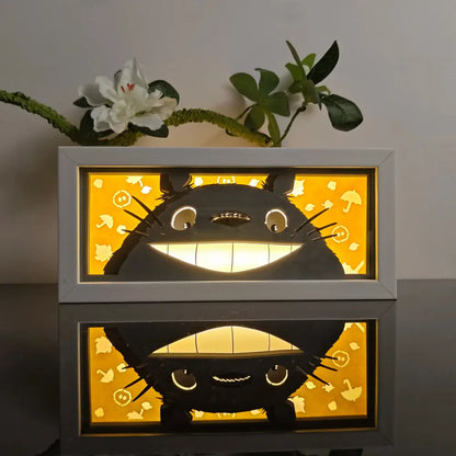 Anime 3d paper carved lamp featuring a black totoro silhouette with warm yellow led backlight and white frame