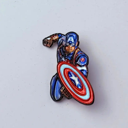 Blue red and white enamel pin featuring captain america in a dynamic pose holding shield anime badge enamel pins