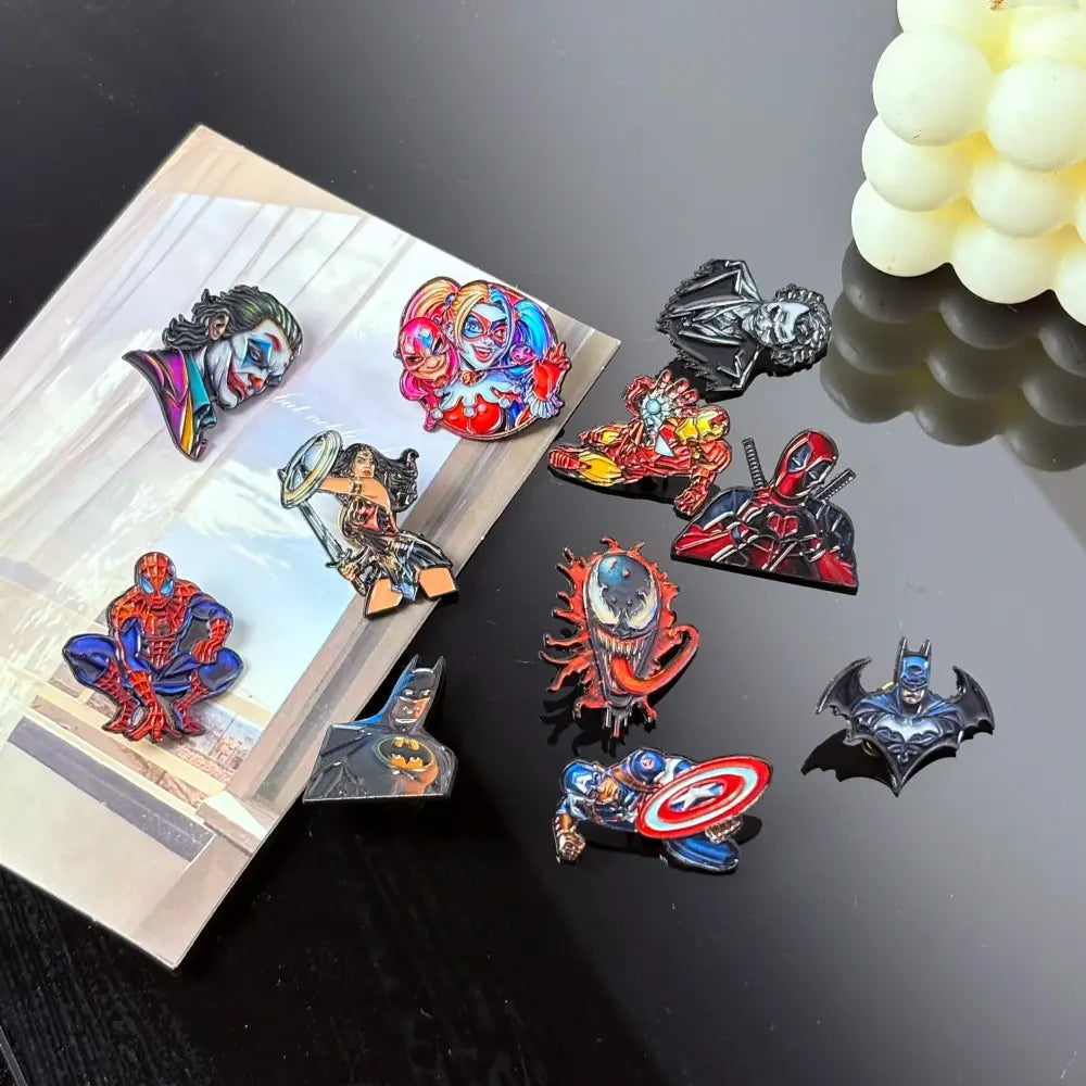 A collection of colorful cartoon anime enamel pins featuring spider-man harley quinn venom and captain america badges
