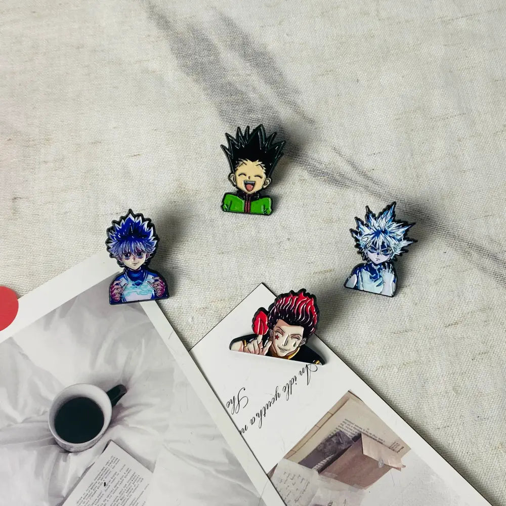 Four colorful anime boy enamel pins featuring hunter x hunter characters with distinct spiky hair and expressions
