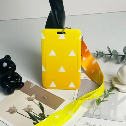 Bright yellow anime card holder with white triangular patterns and matching striped neck strap for id cards