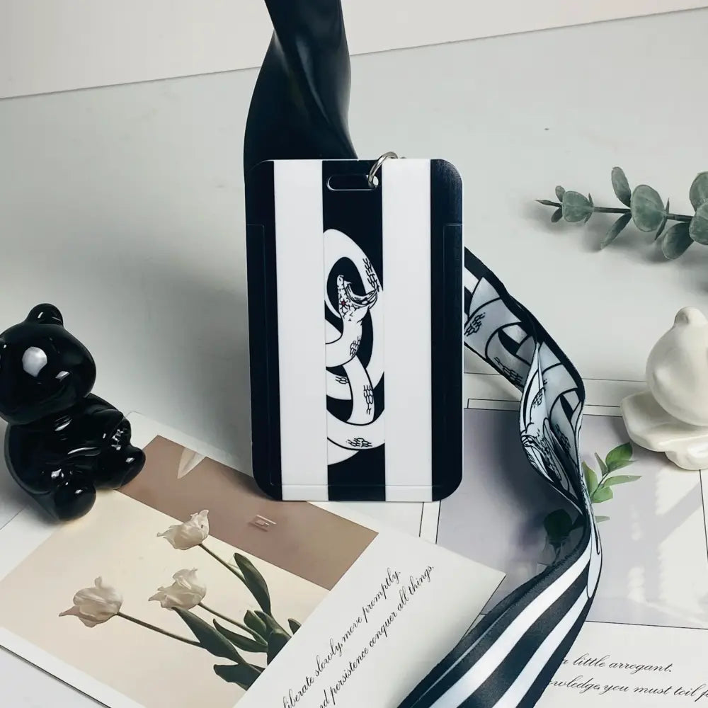 Black and white striped phone case with stylized snake design for anime card holder neck strap and card holder use