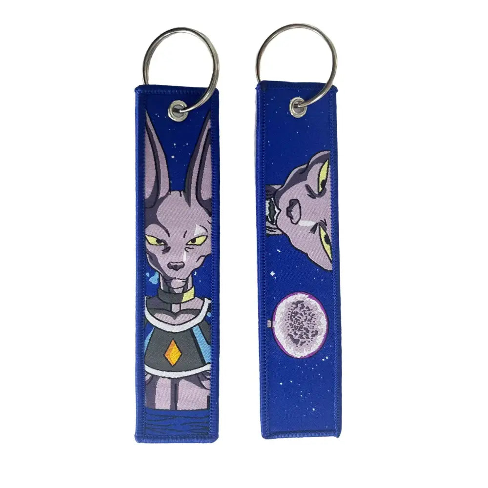 Blue embroidered key fob featuring a cartoon character with long ears and yellow eyes on a starry night sky key tag