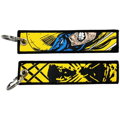 Two embroidered key fobs featuring vibrant yellow blue and black yellow wolverine comic book designs key tag keychains