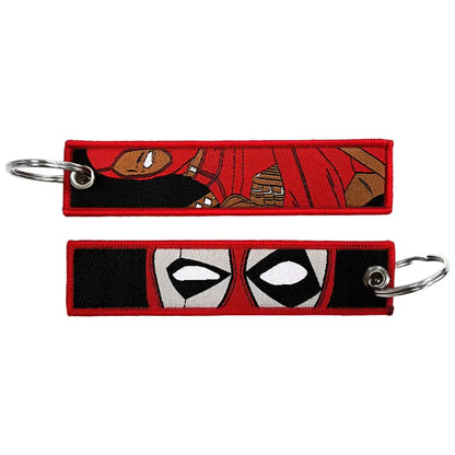 Red embroidered deadpool keychain with black and white eye design as an anime cartoon embroidered key fob and key tag