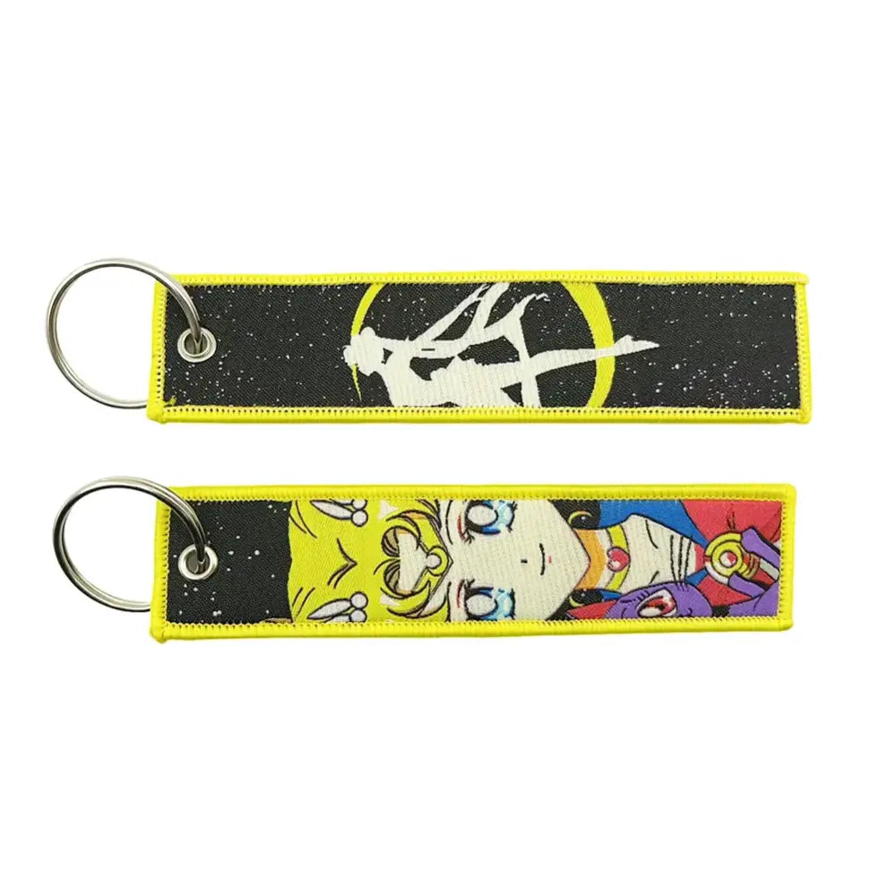 Yellow-trimmed embroidered key fob featuring sailor moon characters on a black starry fabric key tag
