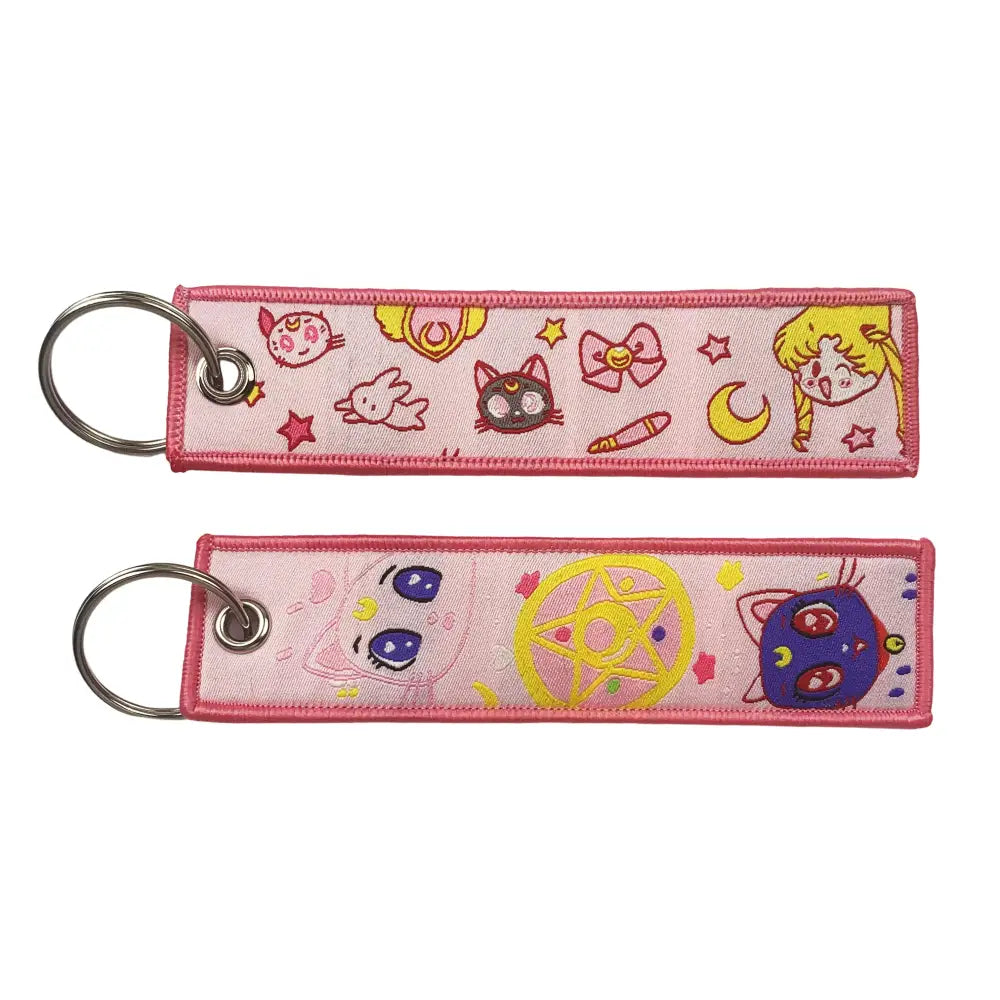 Pink embroidered key fob featuring sailor moon characters and symbols as a key tag keychain accessory