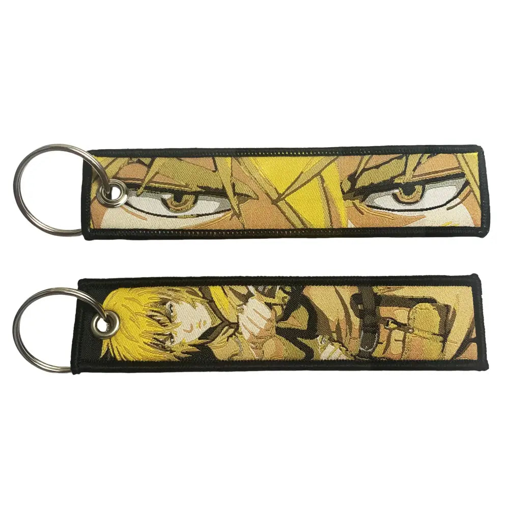 Black embroidered key fob featuring yellow hair anime character designs with detailed facial expressions for key tag use