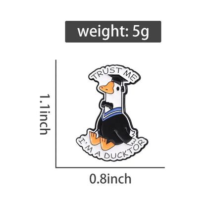 Black and white anime character enamel pin featuring a cartoon duck in graduation gown with trust me im a ducktor text