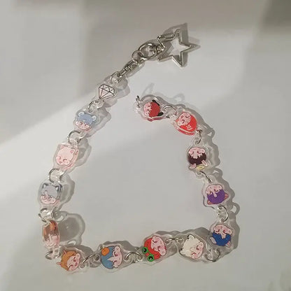 Clear acrylic anime charm bracelet keychain with colorful cartoon pendants and a silver beaded star pendant clasp