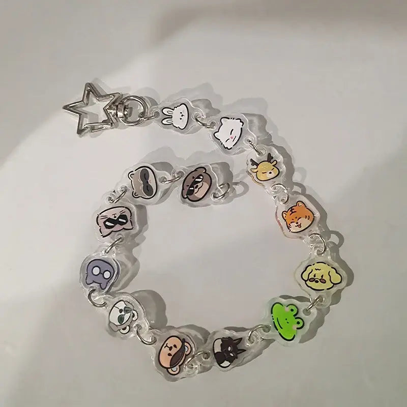 Clear acrylic anime charm bracelet keychain with colorful cartoon animal charms and silver beaded star pendant clasp