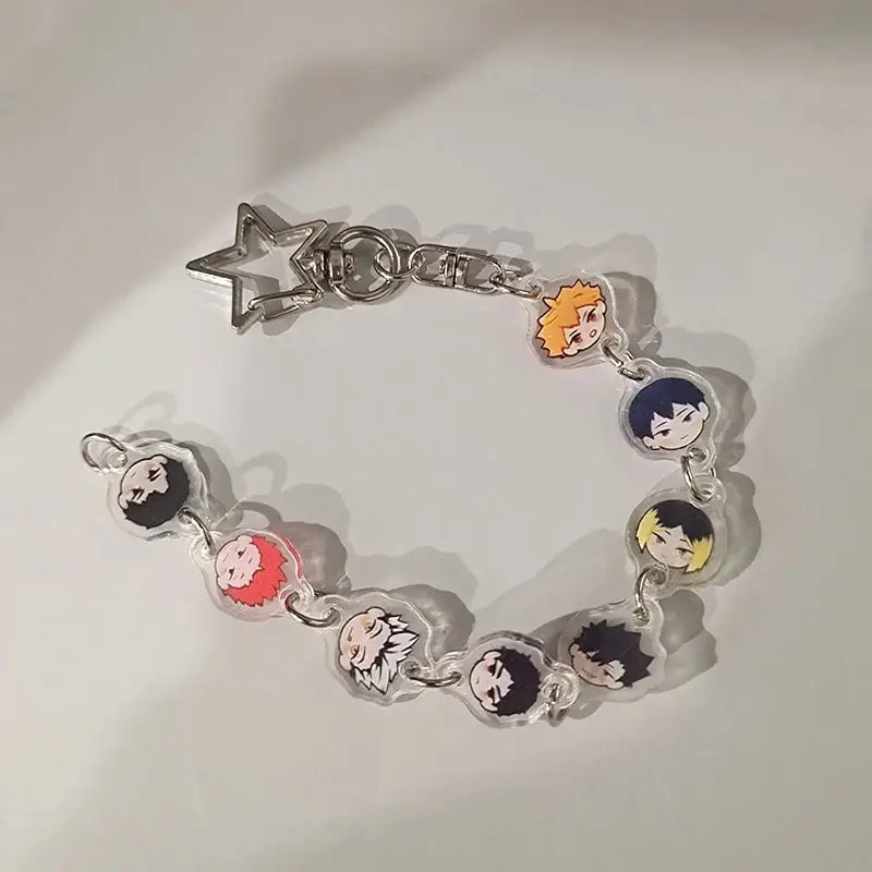 Clear acrylic anime charm bracelet keychain with colorful character charms linked by silver beaded star pendant clasp