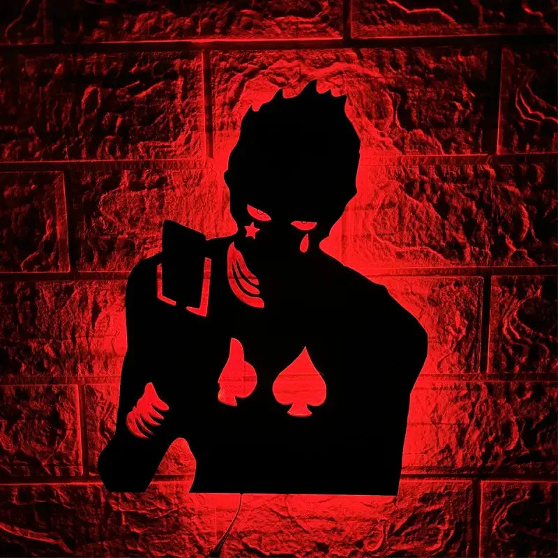 Black silhouette led wall lamp shaped like anime character with spade symbols holding cards illuminated by red light