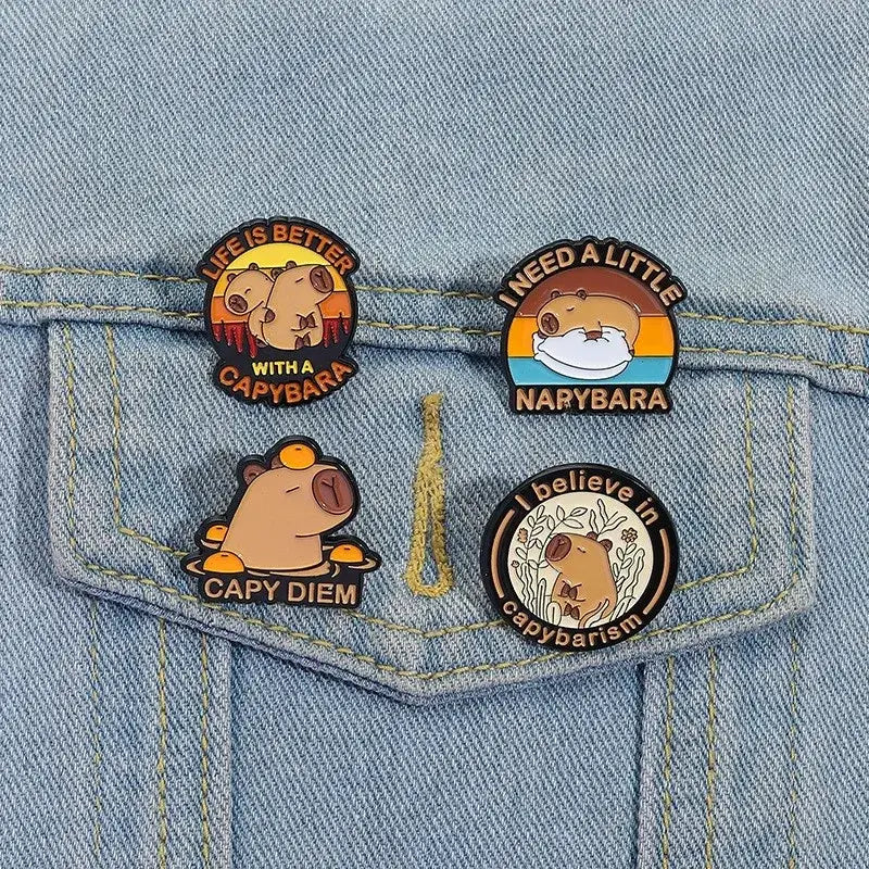 Set of four round anime enamel brooch pins featuring cute capybara designs with colorful backgrounds and funny phrases