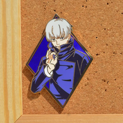 Diamond-shaped anime enamel pin featuring a silver-haired character in a blue coat on a royal blue background