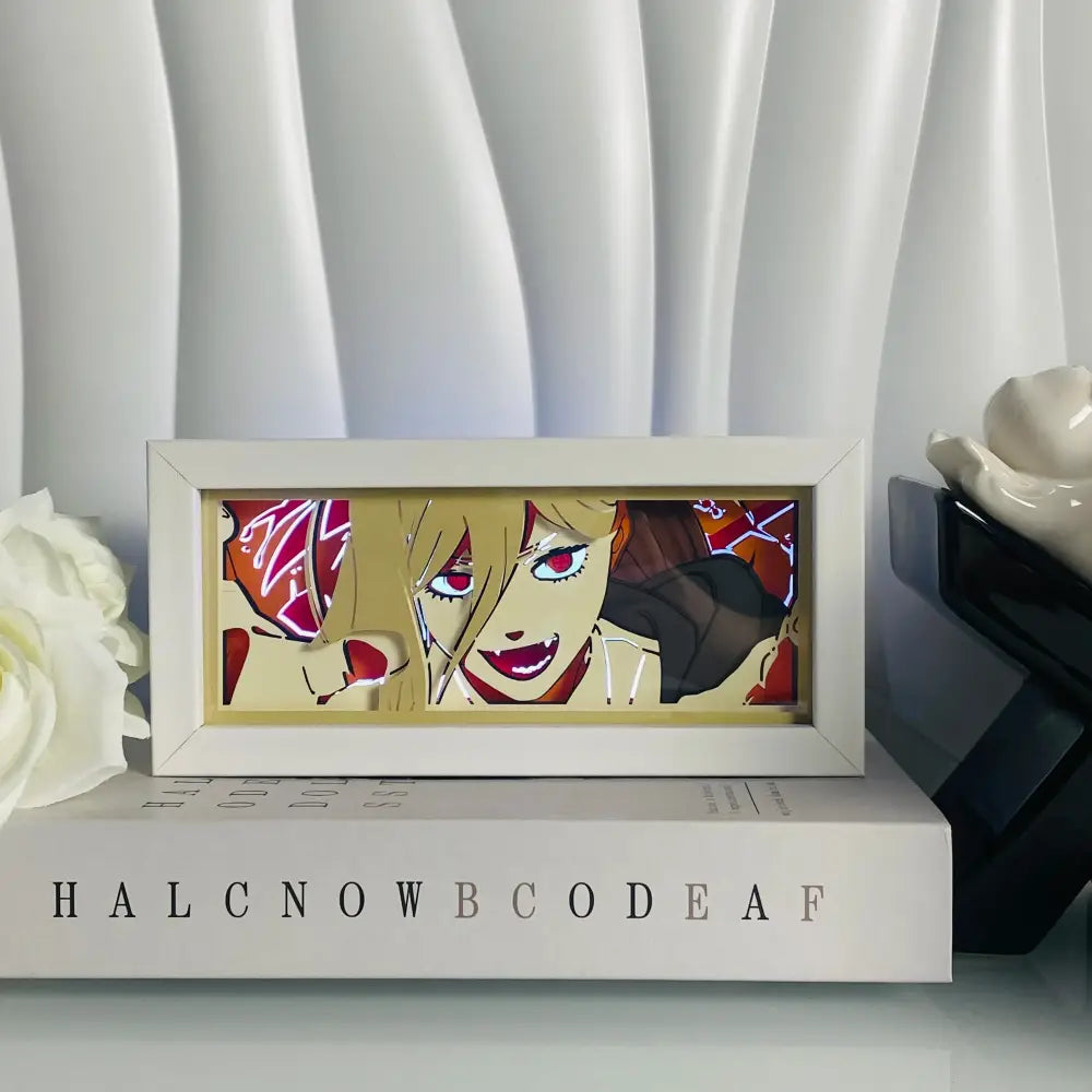 White framed anime eyes shadow box led lamp with layered paper carving in vibrant red orange and gold colors