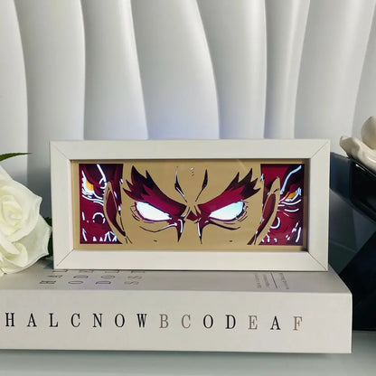 A framed anime eyes shadow box led lamp featuring a red-haired character with glowing white eyes on gold background