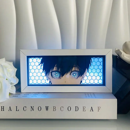White-framed led light box with anime eyes 3d paper carving and glowing blue eyes on honeycomb background