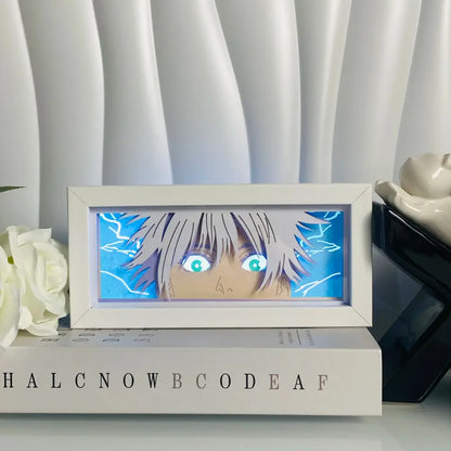 White-framed anime eyes shadow box led lamp with glowing turquoise eyes and silver hair against blue lightning light box