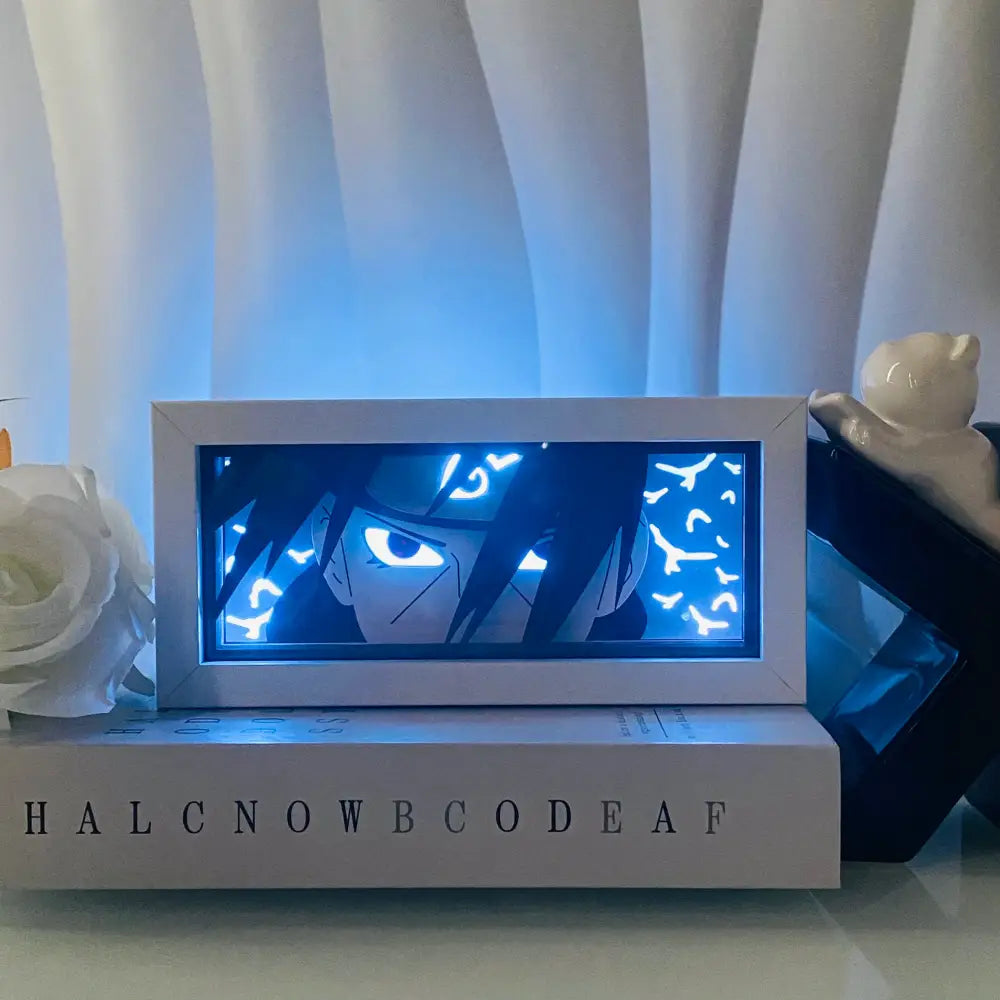 A rectangular white-framed led light box featuring a glowing blue anime eyes silhouette in 3d paper carving style