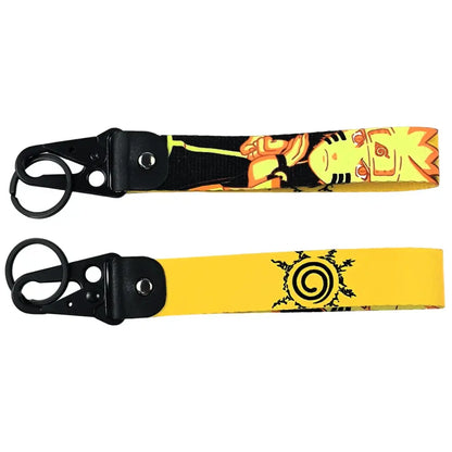 Two naruto-themed anime figure eagle metal keyring keychains featuring an orange jumpsuit design and uzumaki clan symbol on yellow
