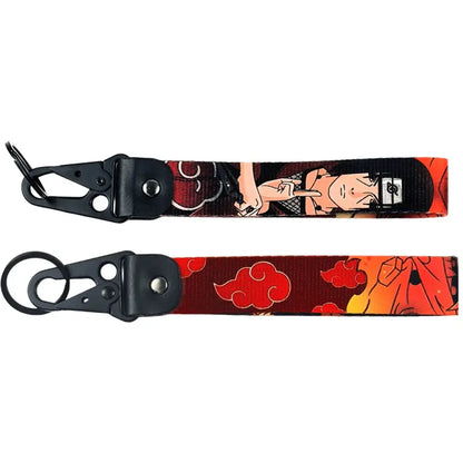 Two black anime figure eagle beak keychains with vibrant red cloud fabric straps and metal keyrings featuring a ninja design
