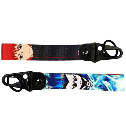 Two anime figure eagle keychains with red and blue characters on metal keyrings featuring eagle beak design