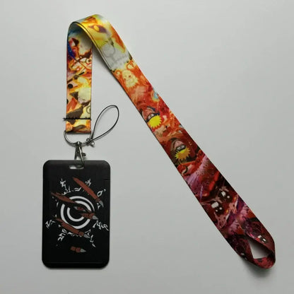Black rectangular badge holder with white and brown design attached to colorful anime id card holder neck strap