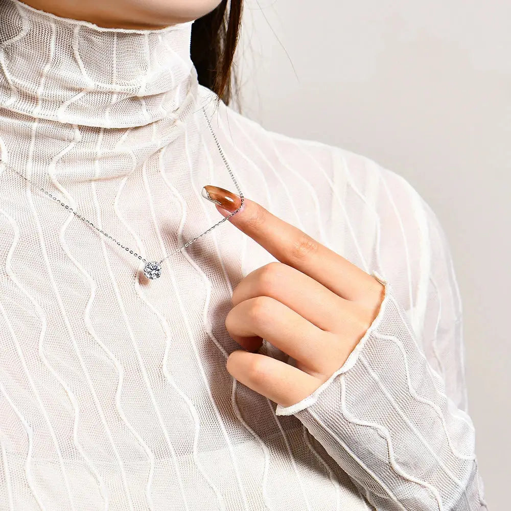 A delicate sterling silver anime-inspired necklace featuring a single d-color moissanite round pendant