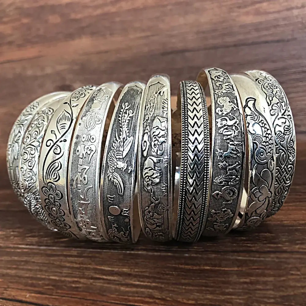 A collection of tibetan silver retro cuff bracelets featuring intricate dragon phoenix and floral engravings