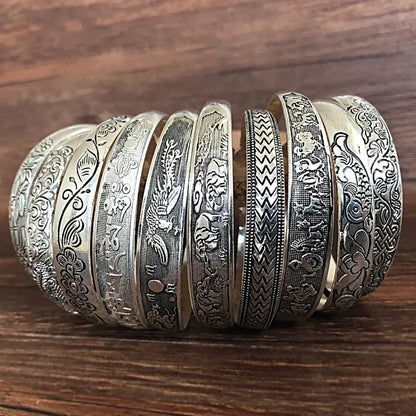 A collection of tibetan silver retro cuff bracelets featuring intricate dragon phoenix and floral engravings