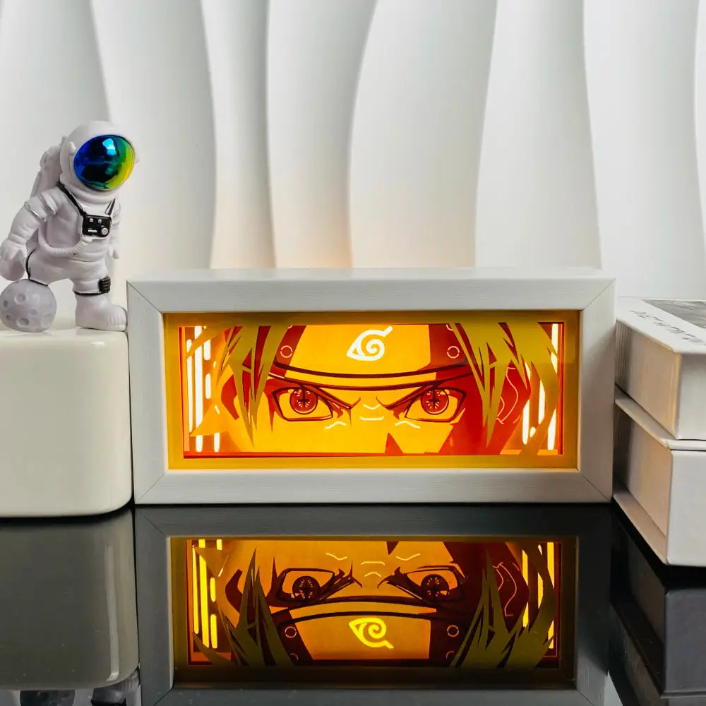 White-framed naruto-themed anime led shadow light box with glowing orange and yellow paper cut wood frame lamp